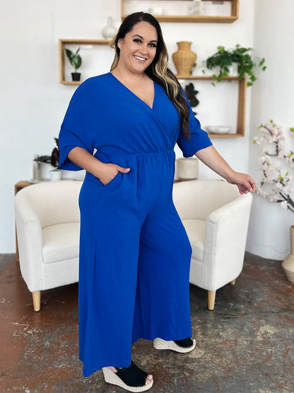 Royal blue Trendsi Double Take full-size surplice wide-leg jumpsuit with pockets, featuring a stylish surplice neckline and flowing wide legs.