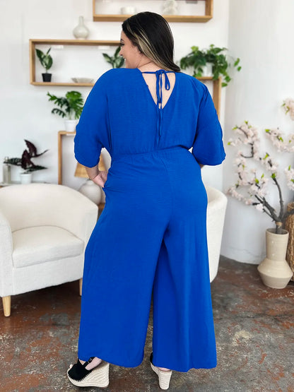 Royal blue Trendsi Double Take full-size surplice wide-leg jumpsuit with pockets, featuring a stylish surplice neckline and flowy pant legs.