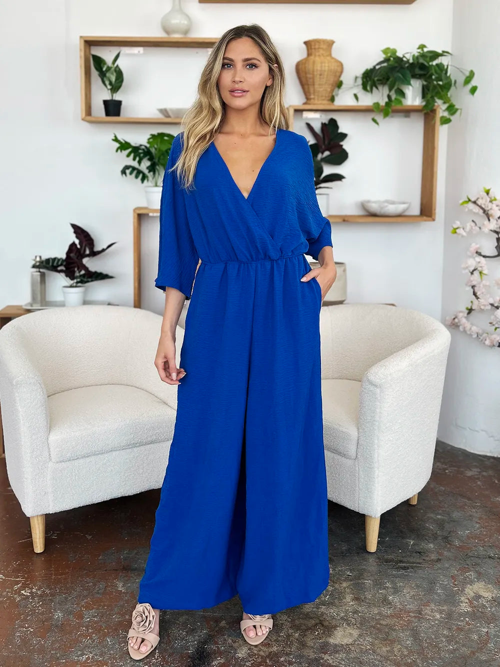 Royal blue Trendsi Double Take full-size surplice jumpsuit with wide legs and front pockets, styled for a chic, comfortable look.