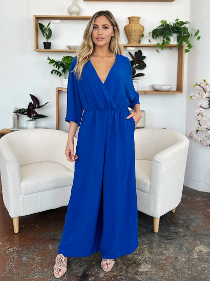 Royal blue Trendsi Double Take full-size surplice jumpsuit with wide legs and front pockets, styled for a chic, comfortable look.