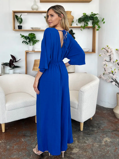Royal blue Trendsi Double Take full-size surplice jumpsuit with wide legs and pockets, styled for a modern, casual look.
