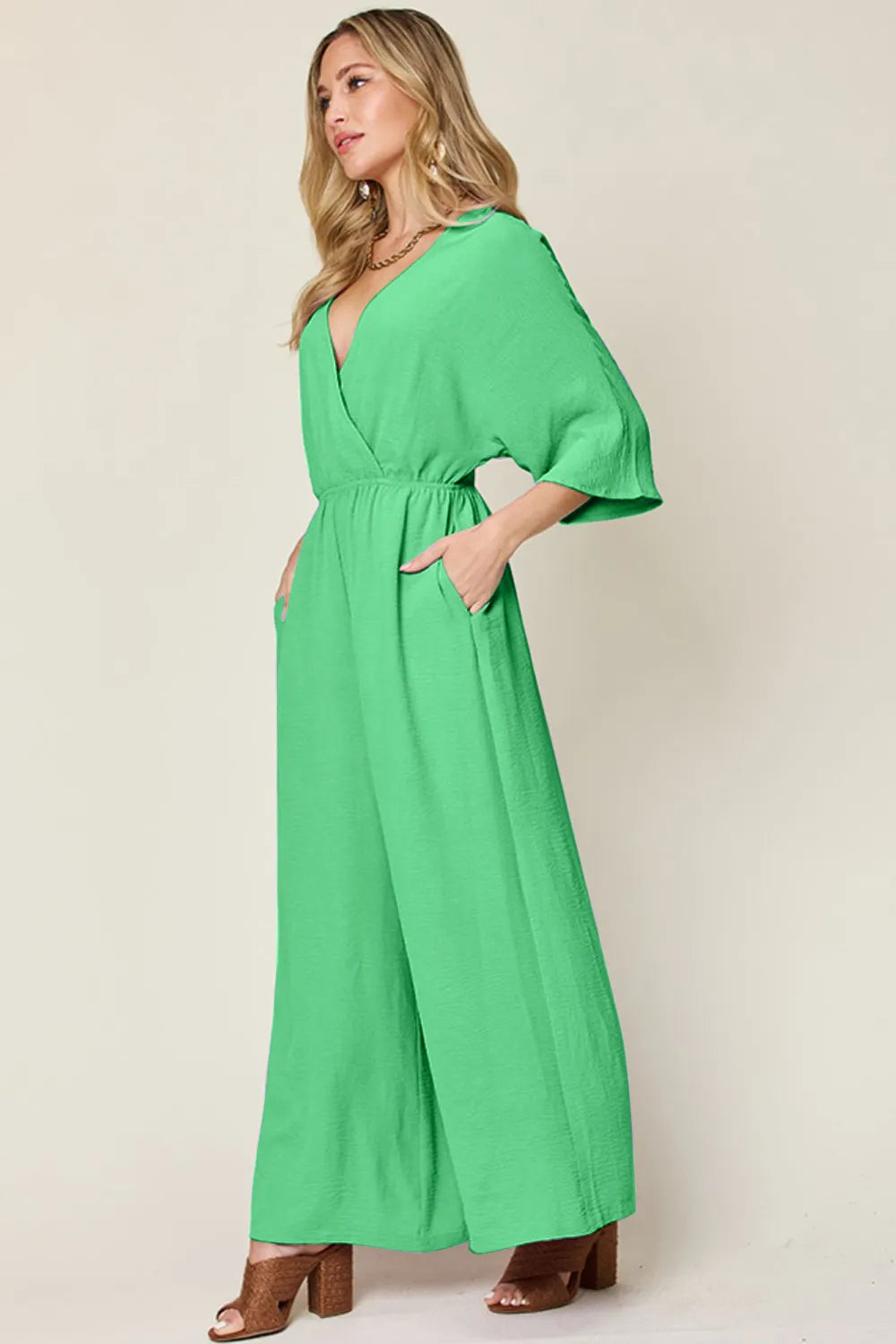 Royal blue Trendsi double take full-size surplice wide-leg jumpsuit with pockets, featuring a stylish surplice neckline and wide-leg design.