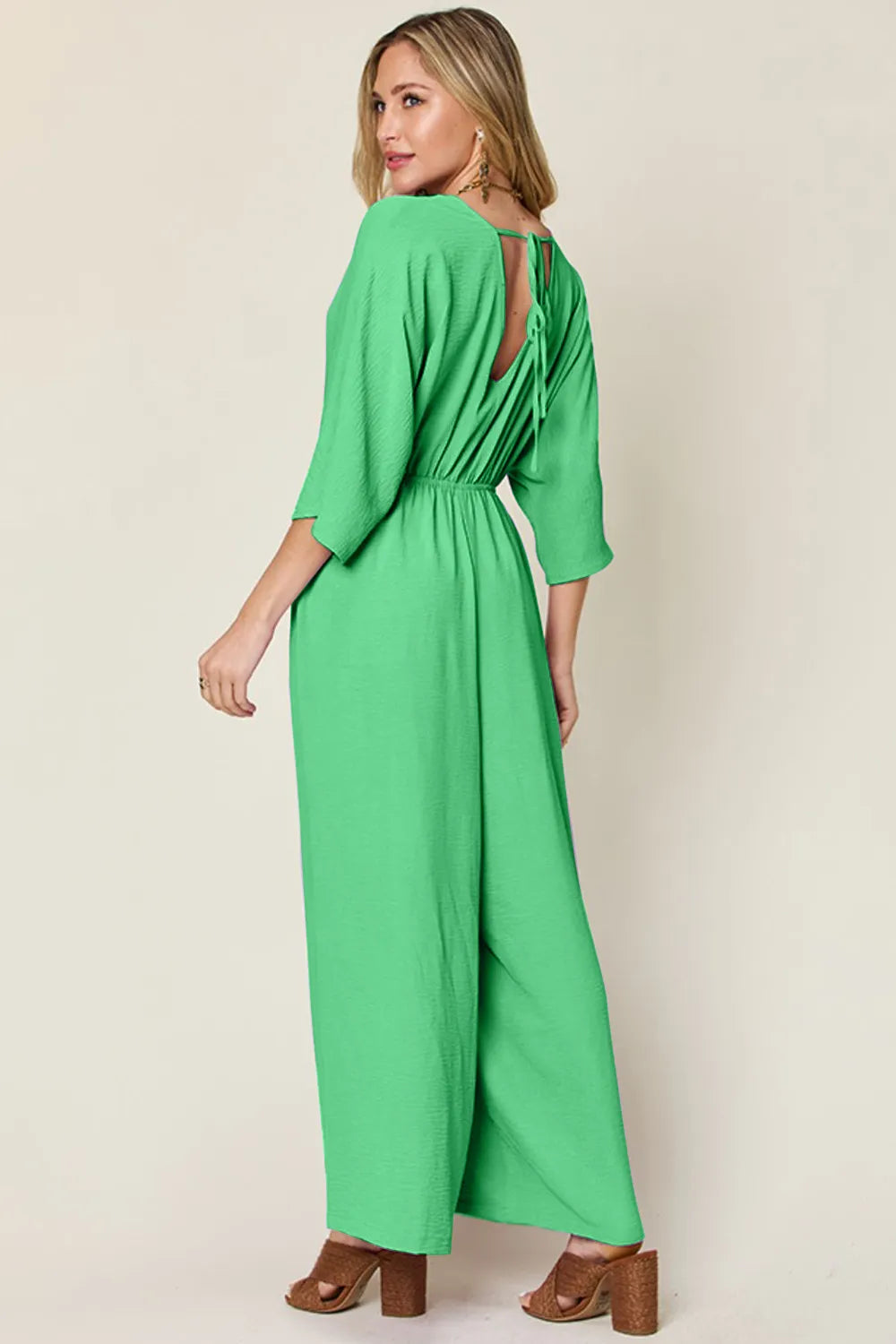 Royal blue Trendsi Double Take full-size surplice wide-leg jumpsuit with pockets, featuring a relaxed fit and elegant design.