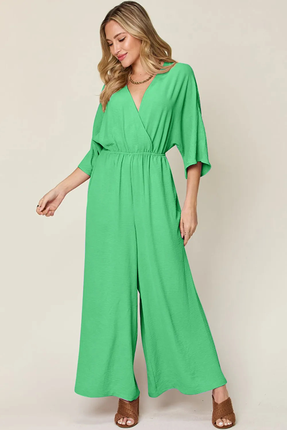 Royal blue Trendsi double take full-size surplice wide-leg jumpsuit with pockets, featuring a stylish, comfortable fit.