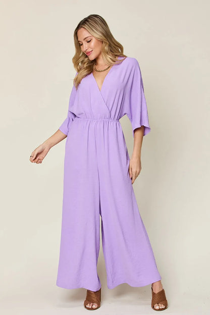 Royal blue Trendsi Double Take full-size surplice wide-leg jumpsuit with pockets, featuring a stylish, comfortable fit.