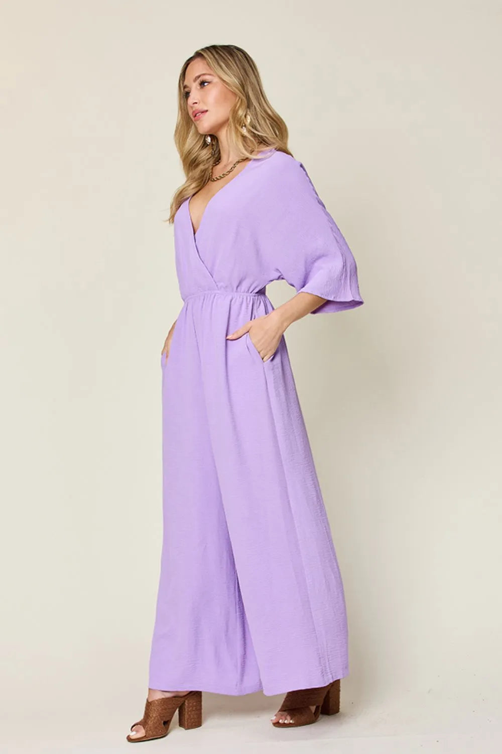 Royal blue Trendsi Double Take full-size surplice wide-leg jumpsuit with pockets, featuring a flattering neckline and comfortable fit.