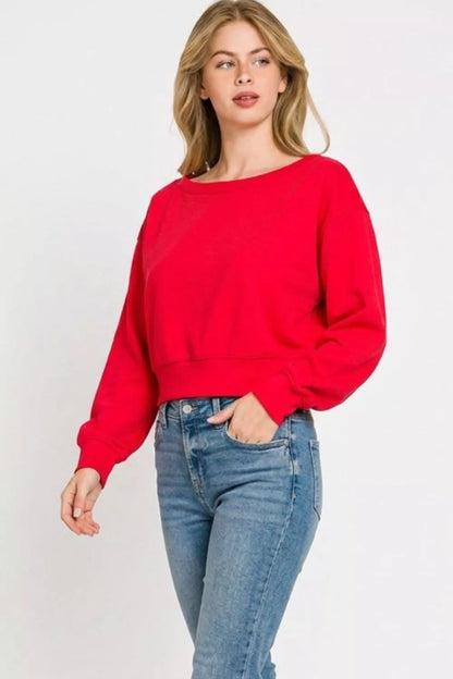 Zenana Scuba Cropped Boat Neck Pullover Sweatshirt from Trendsi, featuring a boat neckline and comfortable cropped fit.