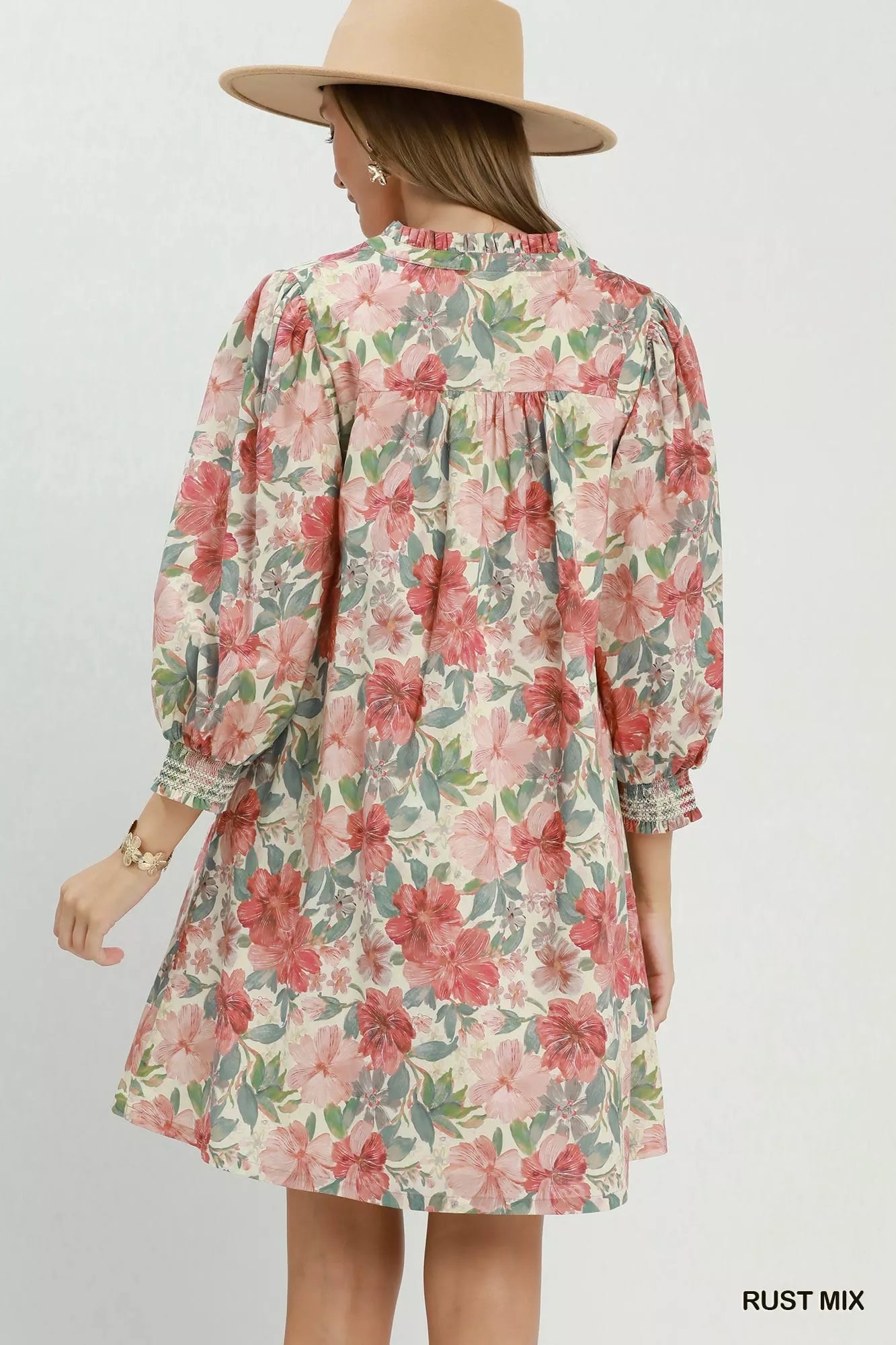 Rust-colored Umgee floral print mini dress with smocked cuffs, featuring a trendy mix floral pattern and a flattering fit.