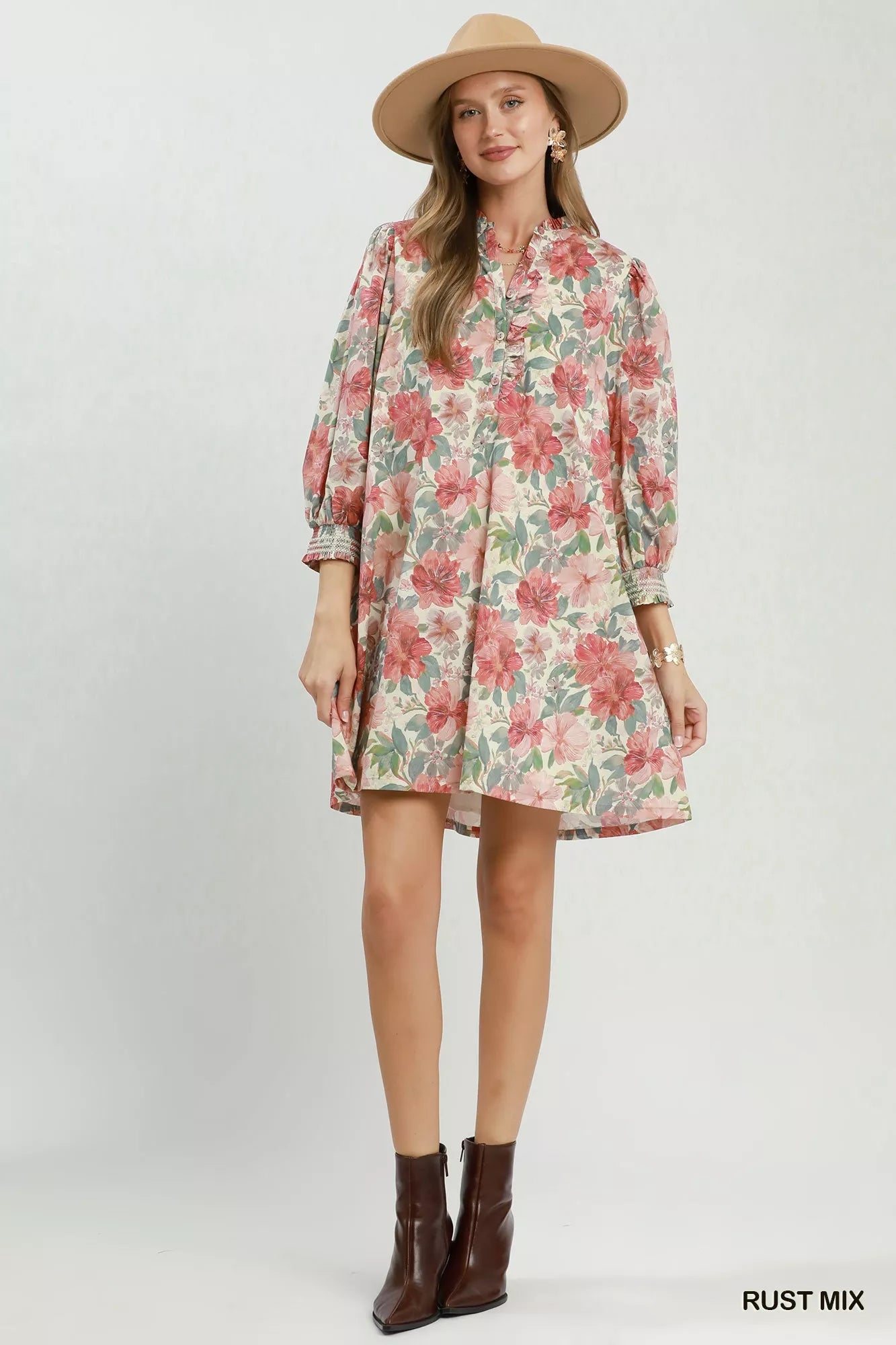 Rust-colored Umgee floral print mini dress with smocked cuffs, featuring a mix of floral patterns and a flattering fit.