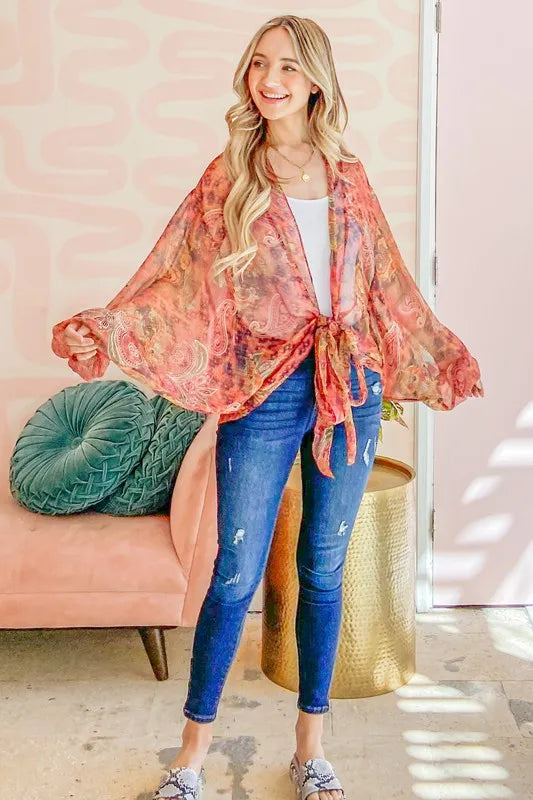 Rust-colored oversized print top with front tie knot from Trendsi, featuring a relaxed fit and stylish design.