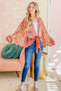 Rust-colored oversized print top with front tie knot from Trendsi, featuring a relaxed fit and stylish design.