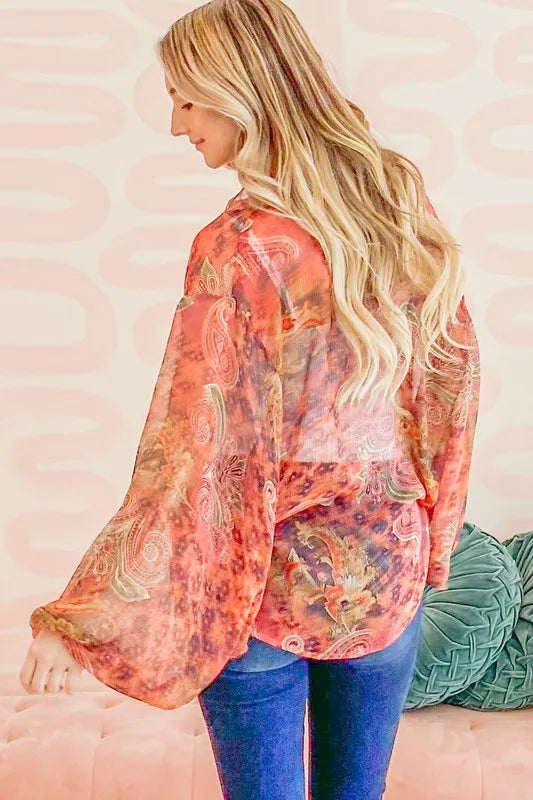 Rust-colored oversized print top with front tie knot and relaxed fit, stylish casual blouse from Trendsi.