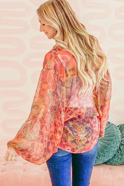 Rust-colored oversized print top with front tie knot and relaxed fit, stylish casual blouse from Trendsi.