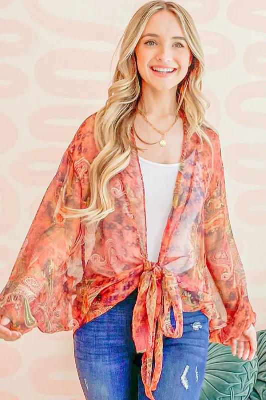 Rust-colored oversized print top with front tie knot from Trendsi, featuring a relaxed fit and trendy design.