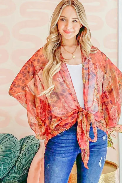 Rust-colored oversized print top with front tie knot from Trendsi, featuring a relaxed fit and bold graphic design.