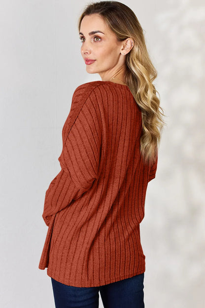Rust-colored Basic Bae full size ribbed long sleeve T-shirt with half-button front, by Trendsi, showing close-up of fabric and button details.