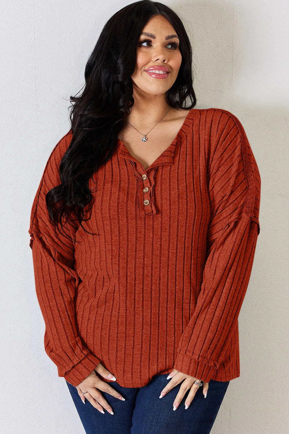 Rust-colored Trendsi Basic Bae full-size ribbed half-button long sleeve T-shirt, showing the ribbed texture and half-button detail.