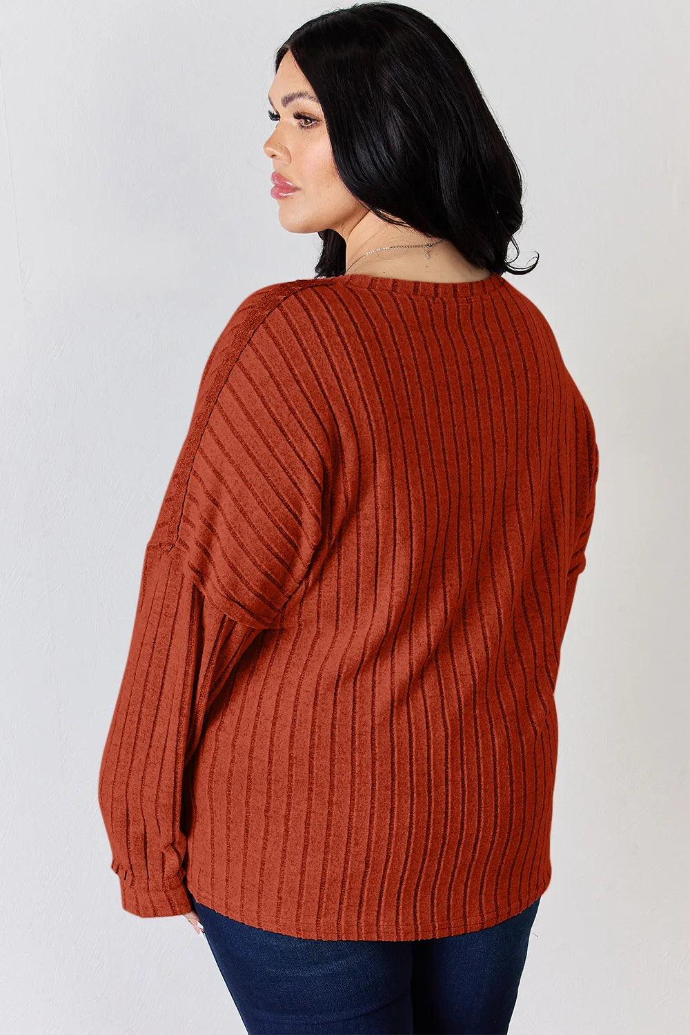 Rust-colored Basic Bae ribbed long sleeve T-shirt with half button detail from Trendsi, featuring a full-size fit and ribbed fabric.