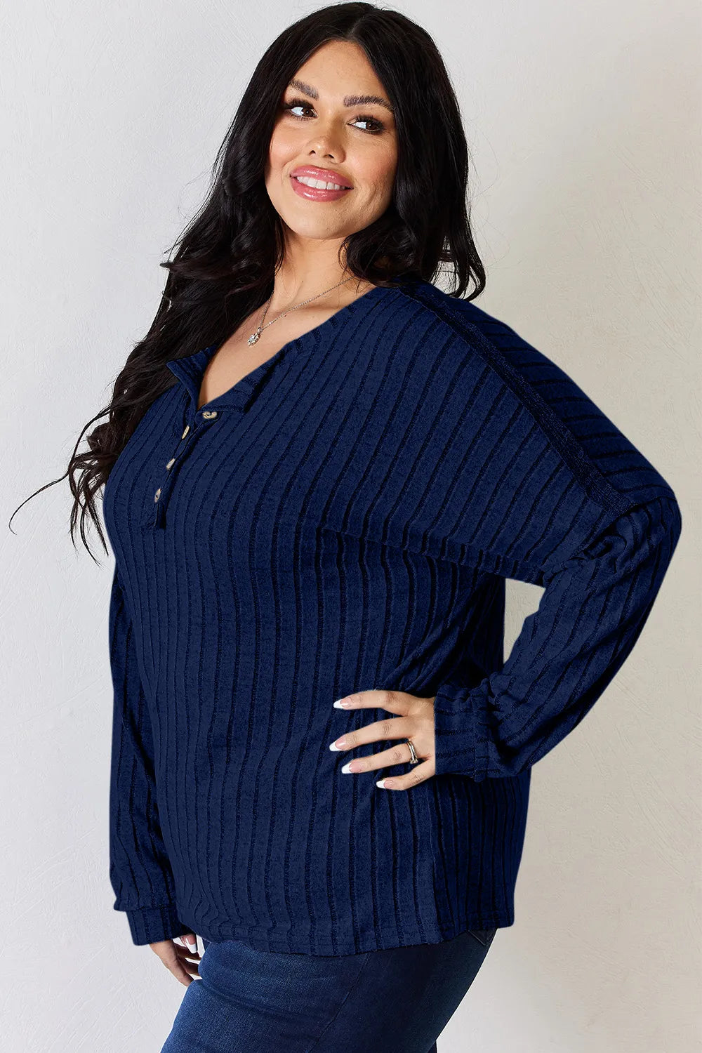 Rust-colored Trendsi Basic Bae full-size ribbed long sleeve T-shirt with half button detail, showing the ribbed fabric and relaxed fit.