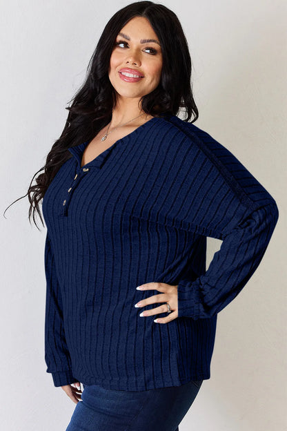 Rust-colored Trendsi Basic Bae full-size ribbed long sleeve T-shirt with half button detail, showing the ribbed fabric and relaxed fit.