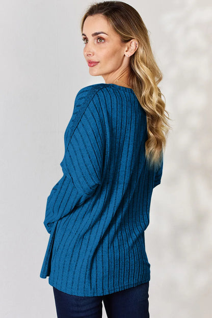 Rust-colored Basic Bae full-size ribbed long sleeve T-shirt with half button front by Trendsi, showing the ribbed texture and collar detail.