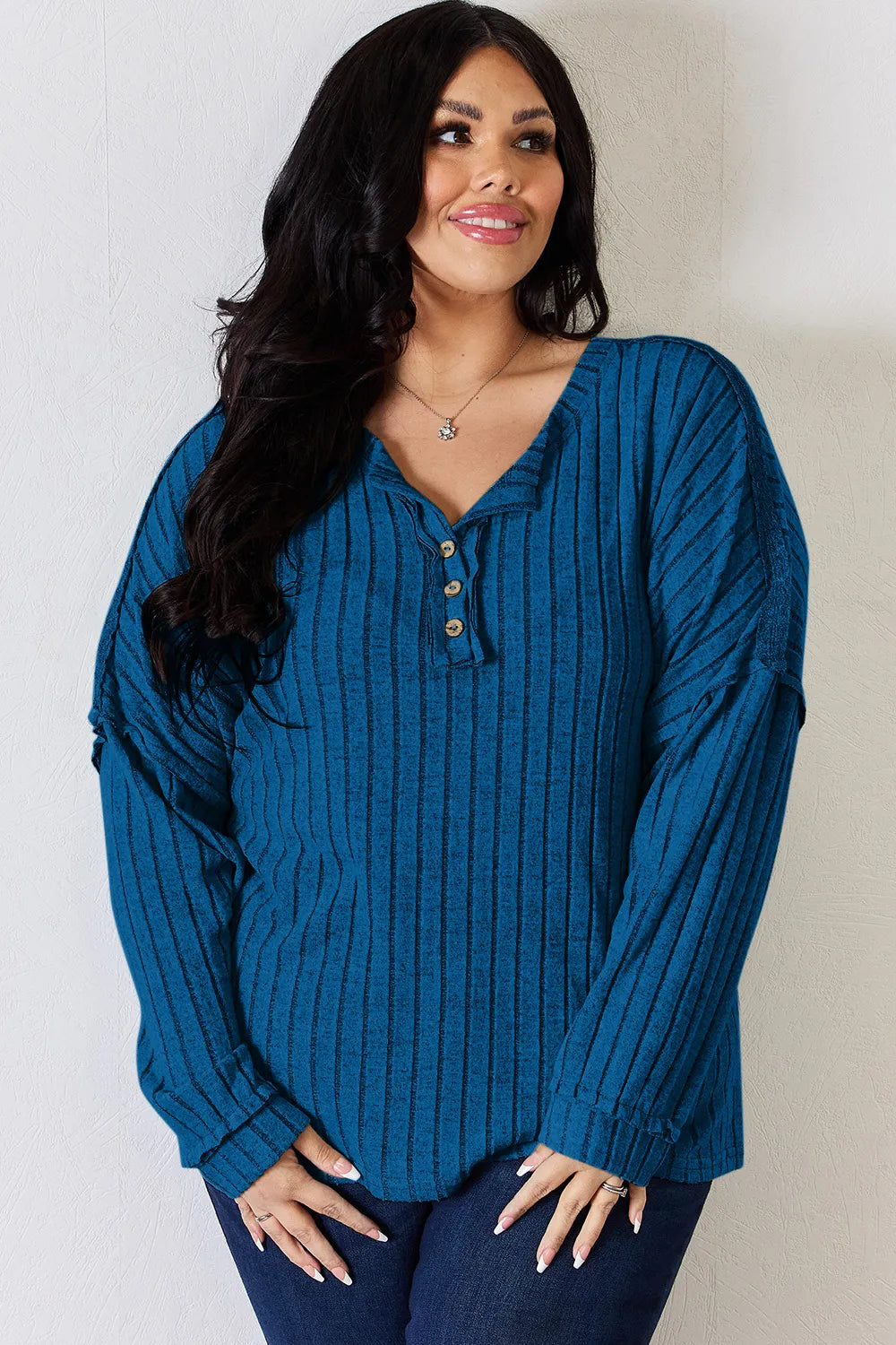 Rust-colored Basic Bae full size ribbed long sleeve T-shirt with half button detail by Trendsi, showcasing the textured fabric and design.