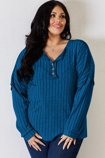 Rust-colored Basic Bae full size ribbed long sleeve T-shirt with half button detail by Trendsi, showcasing the textured fabric and design.