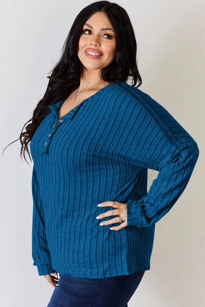 Rust-colored Basic Bae ribbed long sleeve t-shirt with half button front, by Trendsi, showing close-up of fabric and button details.