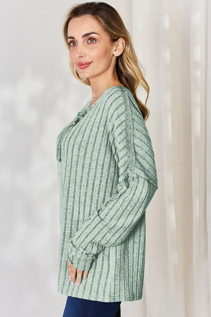 Rust-colored Basic Bae full-size ribbed long sleeve T-shirt with half button front by Trendsi, showing close-up of fabric and design.