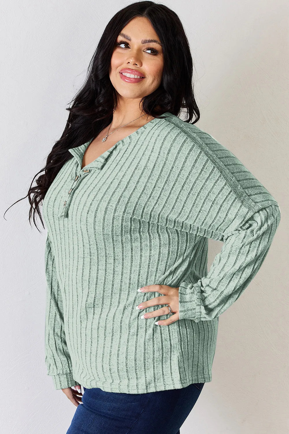 Rust-colored Basic Bae full-size ribbed long sleeve T-shirt with half-button neckline by Trendsi, showcasing its textured fabric.