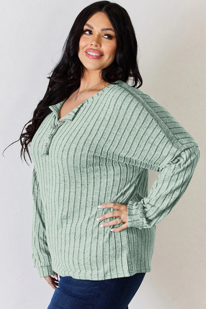 Rust-colored Basic Bae full-size ribbed long sleeve T-shirt with half-button neckline by Trendsi, showcasing its textured fabric.