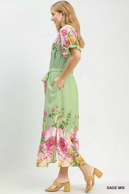 Sage green Umgee floral border print midi dress from Trendsi, featuring a flowy silhouette and feminine floral pattern.