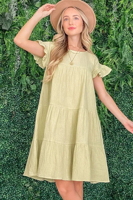 Sage green cotton gauze baby doll casual dress by And The Why from Trendsi, featuring a relaxed fit and lightweight fabric.