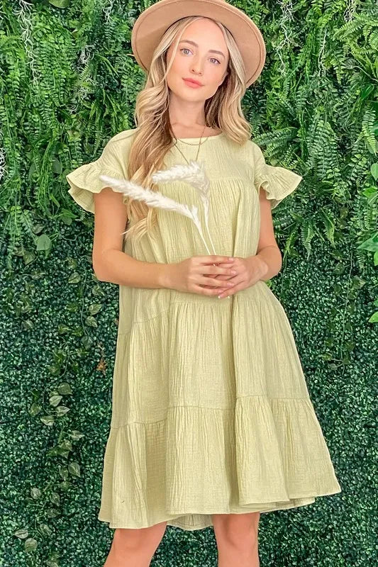 Light sage green Cotton Gauze Baby Doll Casual Dress by Trendsi, featuring a soft, breathable fabric and relaxed fit for comfortable style.
