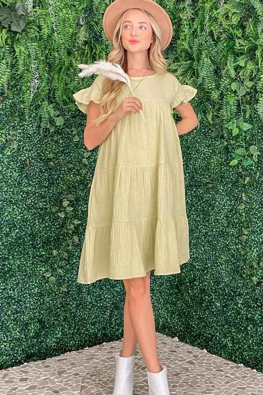 Light sage green cotton gauze baby doll casual dress by Trendsi, featuring a relaxed fit and soft, breathable fabric.