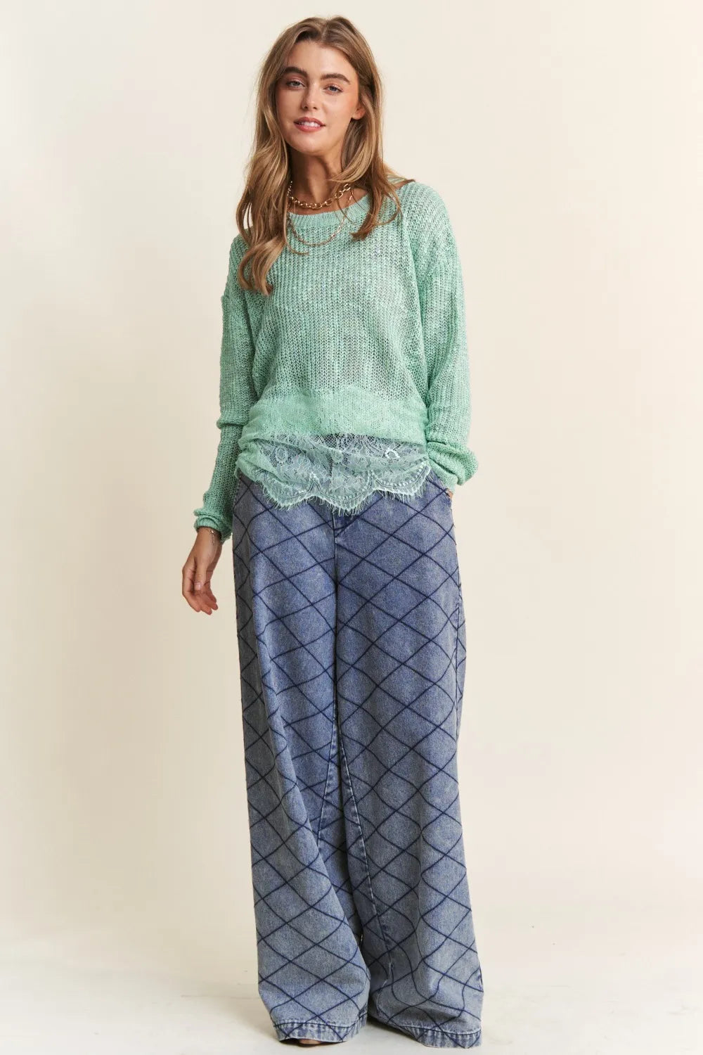 Sage green J.NNA lace detail long sleeve knit top by Trendsi, featuring intricate lace accents and a fitted knit design.