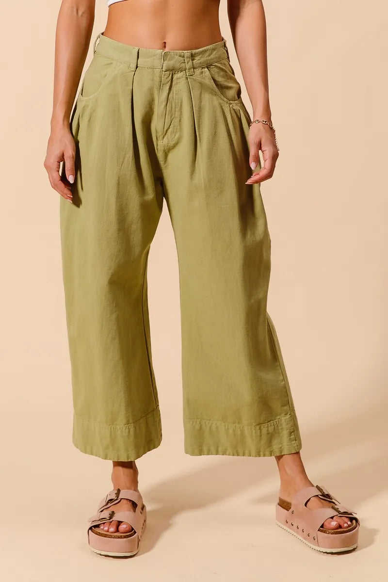 Sage green SO ME mid-rise wide-leg chino pants with front and back pockets, stylish and comfortable for casual wear.