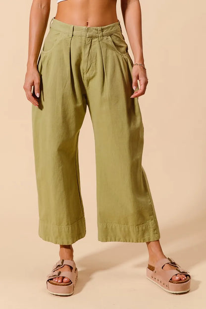 Sage green SO ME mid-rise wide-leg chino pants with front and back pockets, stylish and comfortable for casual wear.