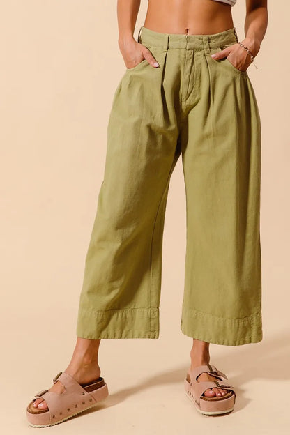 Sage green SO ME mid-rise wide-leg chino pants with side and back pockets, stylish and comfortable for casual wear.