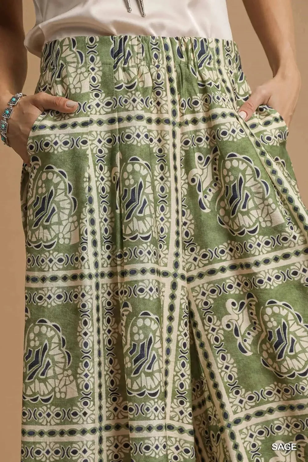 Umgee bohemian print pants with pockets, sage green fabric, relaxed fit, stylish casual wear, Trendsi brand, detailed pattern.