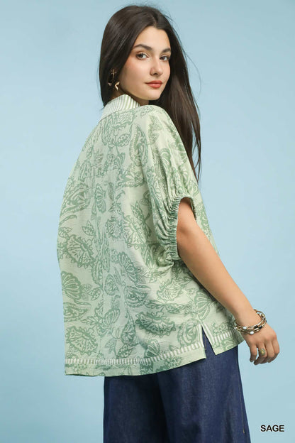 Umgee botanical print mixed trim tunic top in sage color, featuring a relaxed fit and stylish floral design.