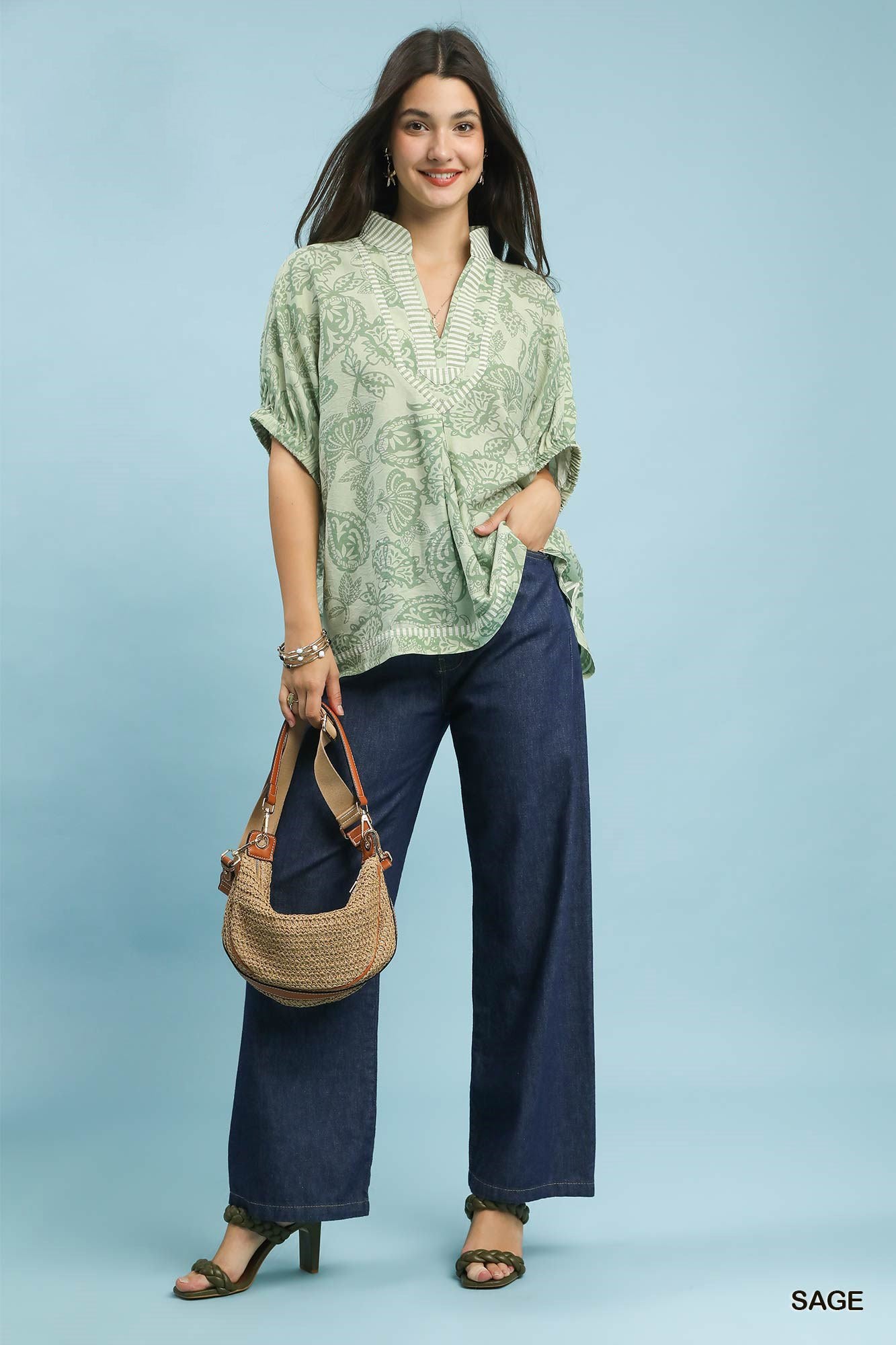 Umgee botanical print mixed trim tunic top with long sleeves and relaxed fit, featuring nature-inspired pattern and contrasting trim details.
