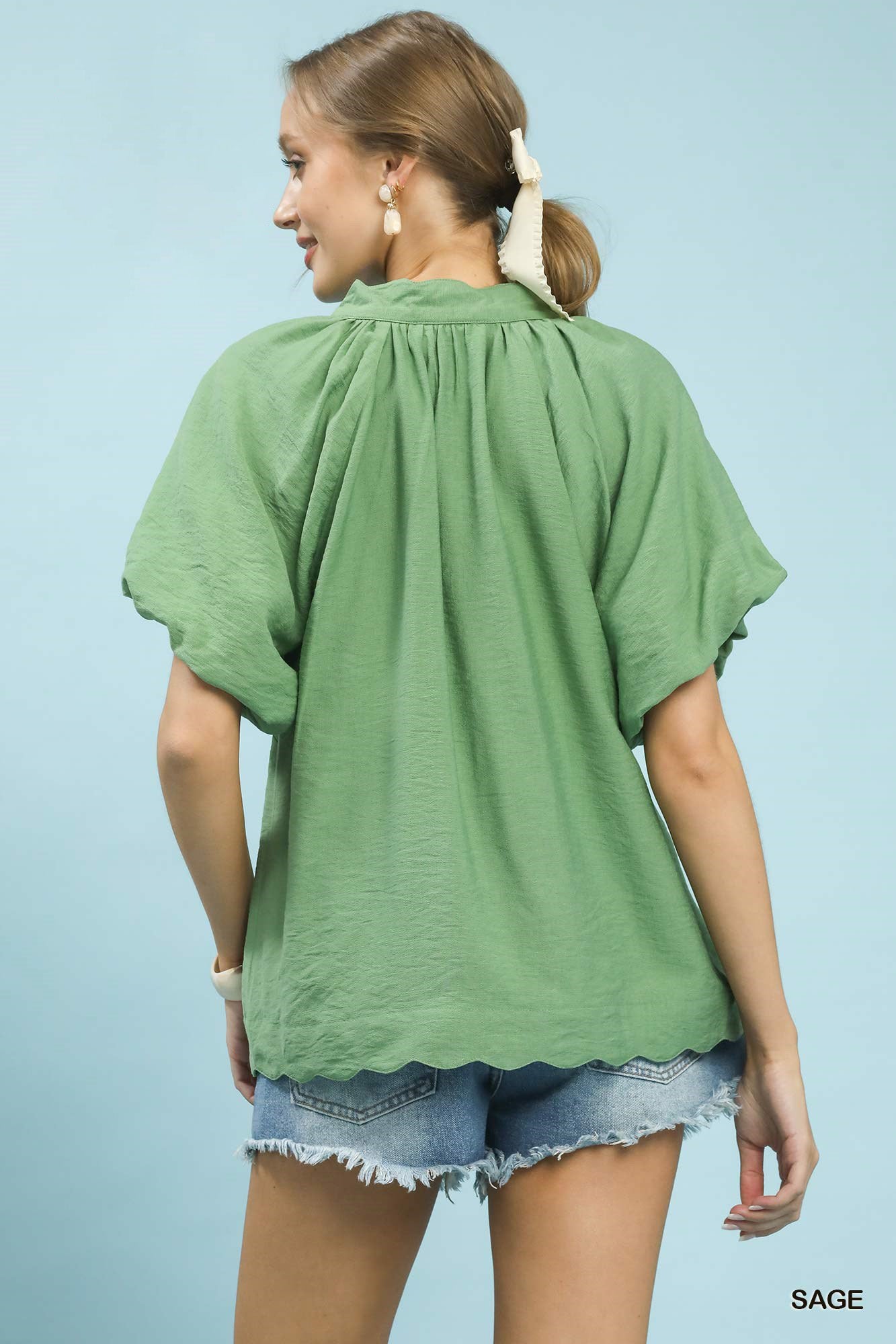 Sage green Umgee floral embroidered hem blouse with long sleeves and relaxed fit, featuring intricate floral embroidery details.