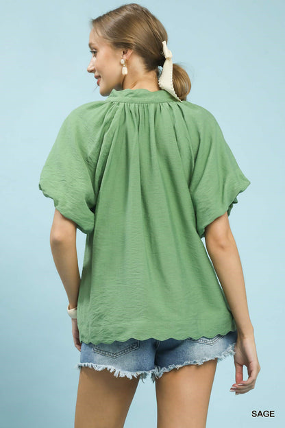 Sage green Umgee floral embroidered hem blouse with long sleeves and relaxed fit, featuring intricate floral embroidery details.