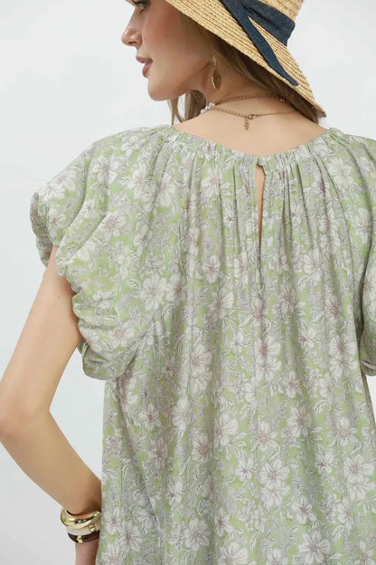 Sage green Umgee floral puff sleeve blouse with ruffled cuffs and a relaxed fit, styled with a floral pattern and lightweight fabric.
