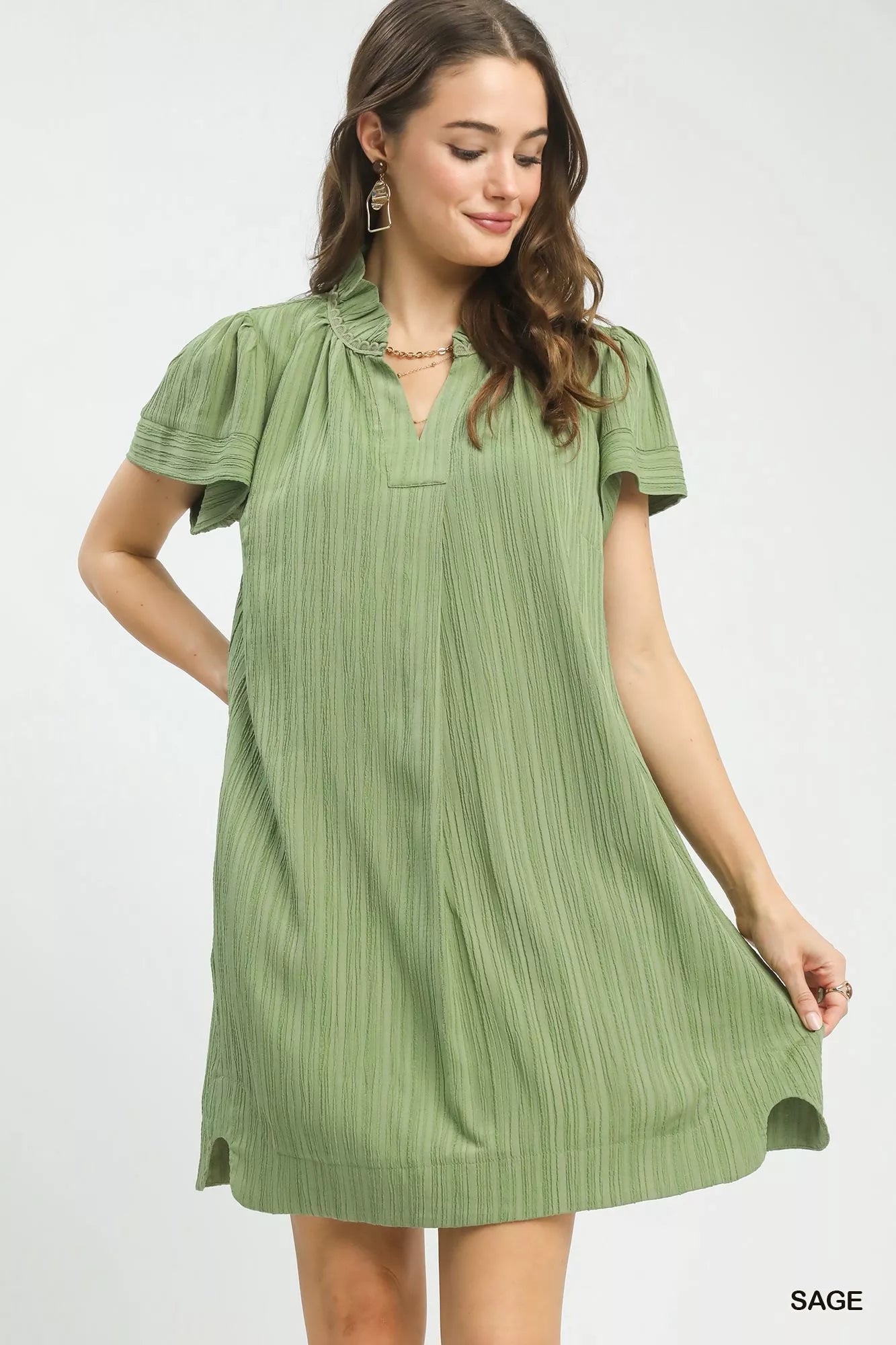 Sage green Umgee Flutter Sleeve V-Neck Shift Dress with relaxed fit and short flutter sleeves, styled for casual wear.