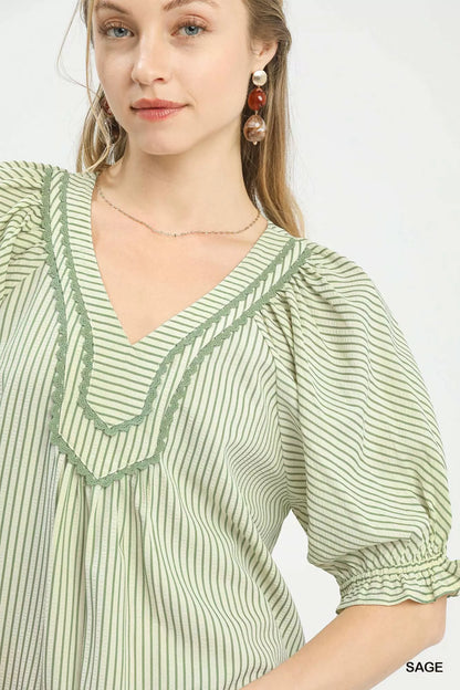 Sage green Umgee Stripe V-Neck Blouse with long sleeves and relaxed fit, styled with subtle vertical stripe pattern.