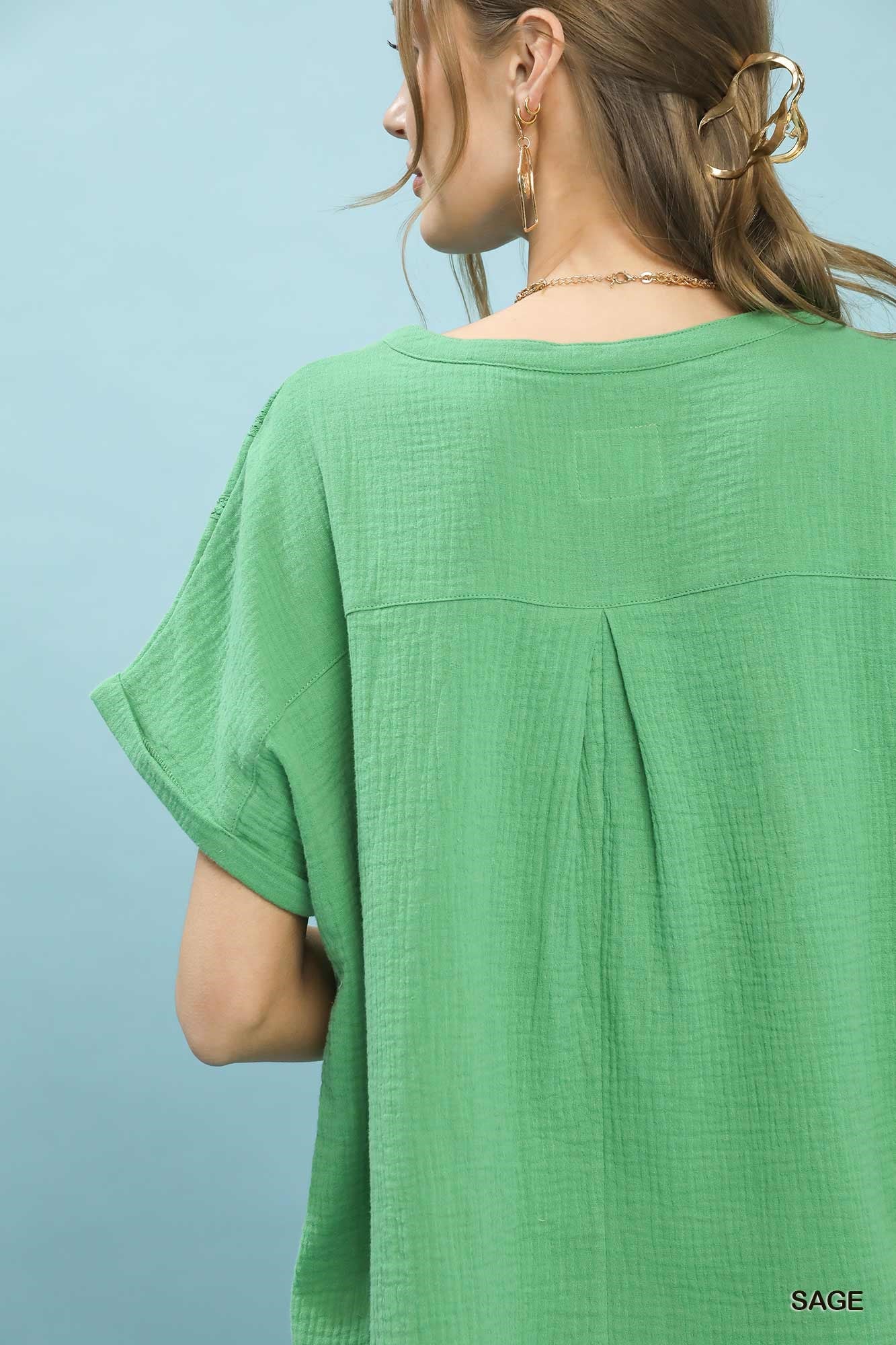 Sage green Umgee textured gauze boho blouse with split neckline and relaxed fit, styled for casual or bohemian looks.