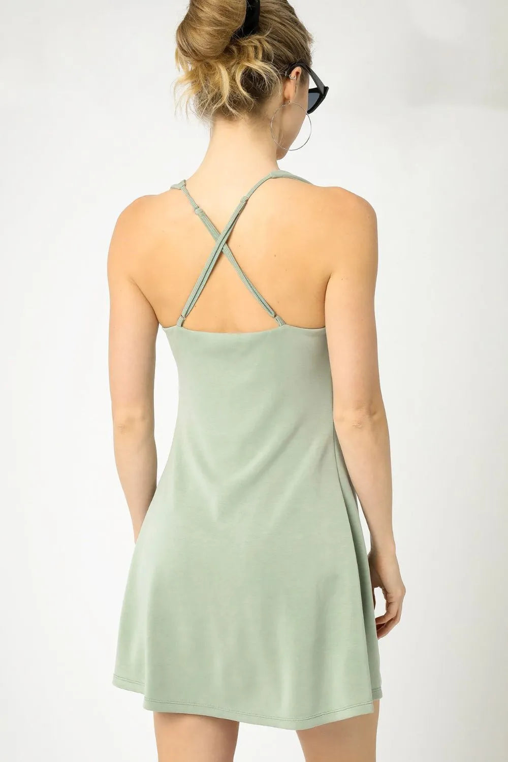 Sage green Umgee crisscross square neck active dress by Trendsi, featuring a fitted silhouette and stylish design.