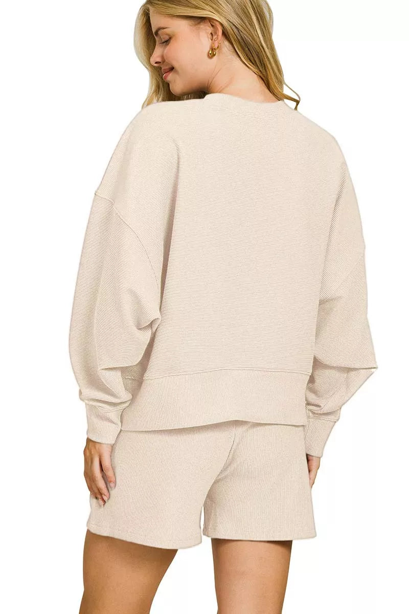 Sand beige Zenana ribbed round neck pullover and shorts set from Trendsi, featuring a cozy, casual knit design.